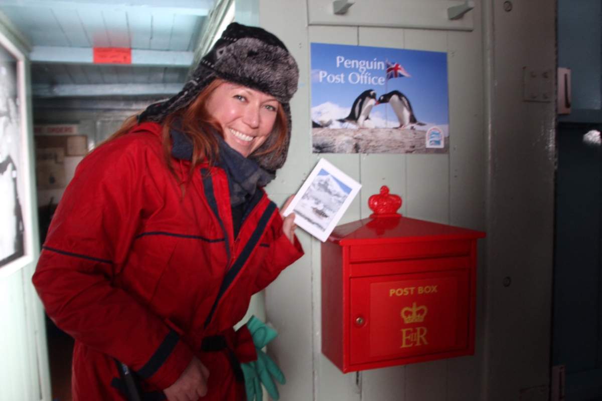 Sending a postcard from the Penguin Post Office at Port Lockroy, Antarctica