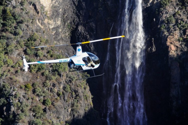 Open door helicopter in front of Dangars Falls, Oxley Wild Rivers National Park, image Fleet Helicopters